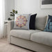 Multiple IKEA cushion covers in different colors and designs on a sofa-60507529