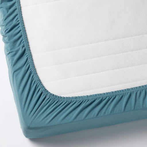 A close-up of an IKEA fitted sheet's elastic edges, showing its stretchiness and durability  20401884