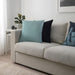 Multiple IKEA cushion covers in different colors and designs on a sofa-60511673