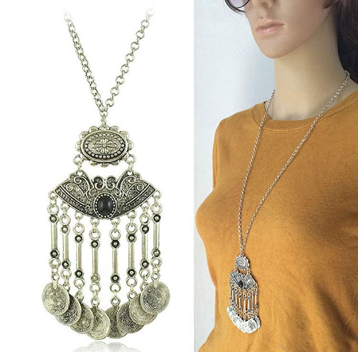 A close-up of a vintage coin long chain necklace with intricate designs.