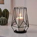 A sleek and stylish metal block candle holder in a black finish, designed to hold a single tea light candle.