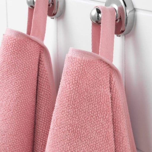 A close-up image of a simple and classic pink hand towel hanging on a bathroom hook10405236