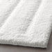 Thick and luxurious white bath mat from IKEA, with a plush texture that provides comfort and warmth to your feet after a shower or bath 70482967