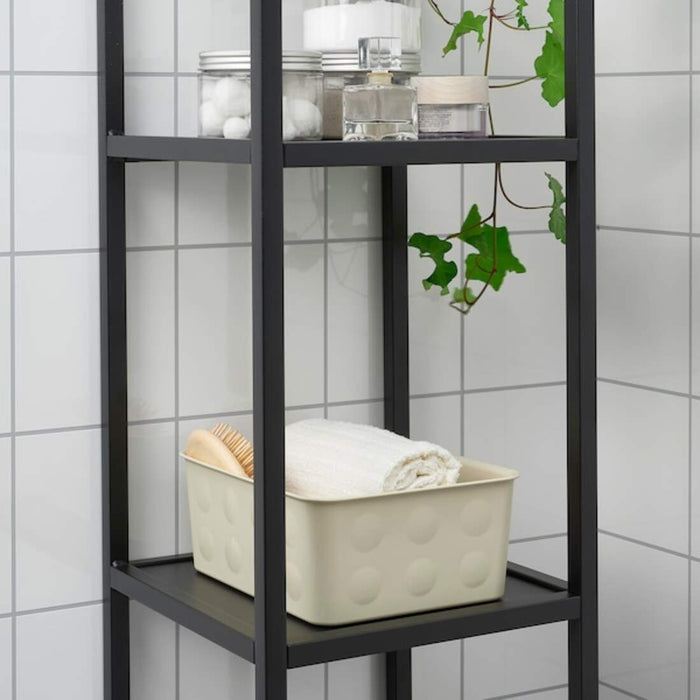 A clear plastic storage basket with handles from IKEA, great for storing bathroom supplies, cleaning supplies, or pantry items.