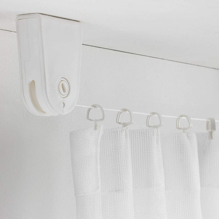 A window with a curtain hanging from the IKEA Curtain Wire in White, showing how the wire creates a clean and streamlined look.