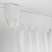 A window with a curtain hanging from the IKEA Curtain Wire in White, showing how the wire creates a clean and streamlined look.