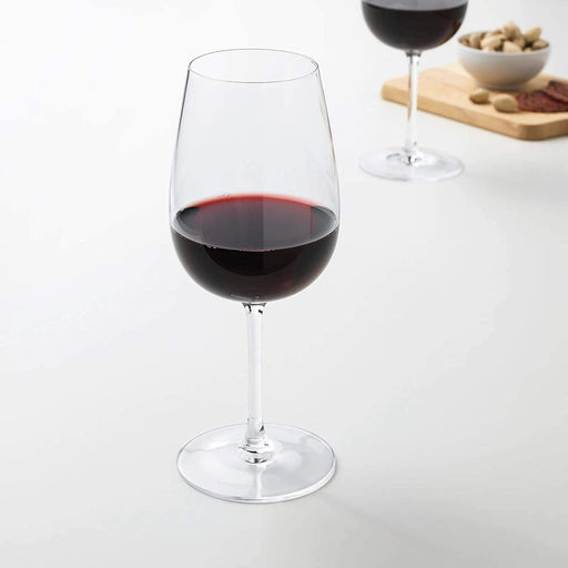 A clear glass IKEA wine glass, featuring a long stem and a tall, narrow bowl that is perfect for holding red wine or other light-bodied wines. 