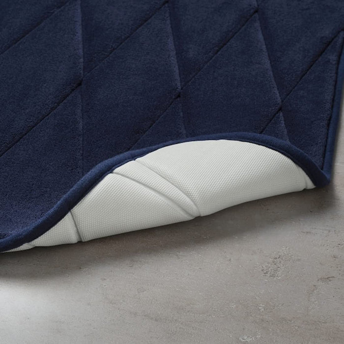 An IKEA bath mat with a pebble-like texture in a calming seafoam