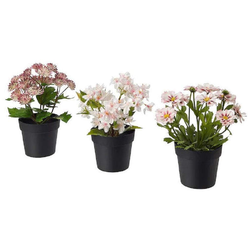 "An affordable and low-maintenance artificial flower potted plant with green leaves and white flowers sitting on a white desk.