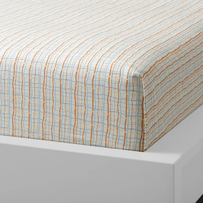 Orange and blue checkered cotton flat sheet and 2 pillowcase set from IKEA draped on a bed 905.075.42