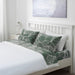 Green cotton flat sheet and 2 pillowcase set from IKEA on a bed  90520708