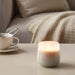 An aromatherapy candle in a glass jar, with a carefully chosen blend of essential oils to promote well-being.