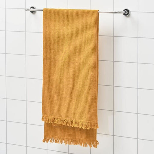 A hand reaching for a folded bath towel on a bathroom shelf.40502231