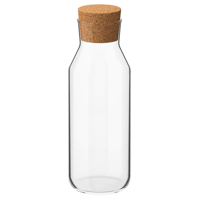 IKEA Carafe with Stopper, Clear Glass, Cork (0.5 l (17 oz)) IKEA Carafe with Stopper - Clear Glass and Cork - 0.5 L Capacity - A side view of the carafe, with the clear glass and cork stopper in focus. - digitalshoppy.in