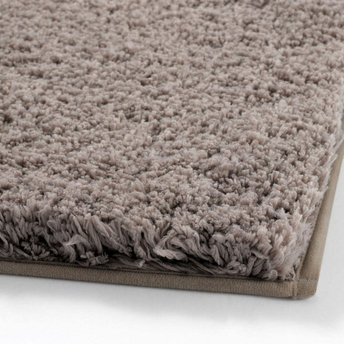 Thick and luxurious Beige bath mat from IKEA, with a plush texture that provides comfort and warmth to your feet after a shower or bath 00489420