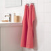 An image of an IKEA hand towel in a red and white striped pattern, adding a classic and timeless touch to any bathroom.00439430