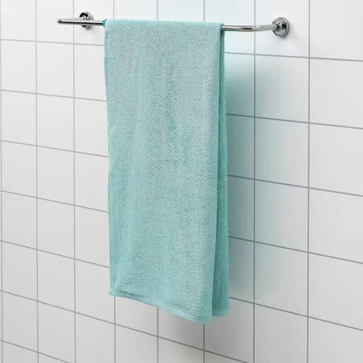 Soft and comfortable cotton towel draped over a bathroom counter 60512856