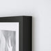 A classic black photo frame that brings a touch of elegance to any room 90378446