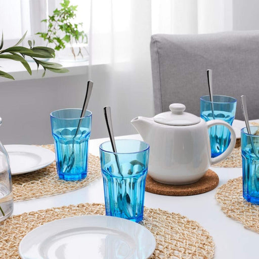 A close-up of an IKEA blue glass, 35 cl, filled with a clear beverage 00461020
