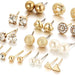 A set of 12 pairs of women's stud earrings, featuring various designs with crystals and simulated pearls.