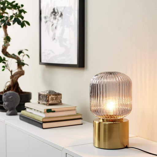 IKEA SOLKLINT table lamp brass and glass shade side profile view showing textile cord detail