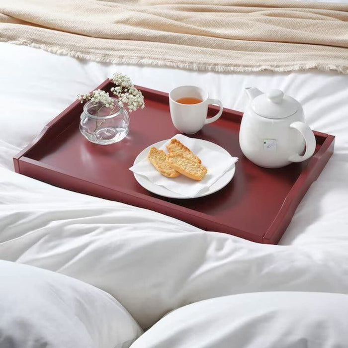 "A close-up of the IKEA Tray Table with a tray and a cup of coffee"