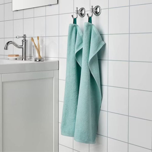 An image of a Turquoise hand towel hanging from a hook on a bathroom wall 30512872