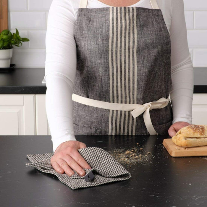 A female wearing a grey apron and cleaning the surfaces 70479578