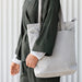 "A beige IKEA tote bag with handles and a front pocket, perfect for everyday use."