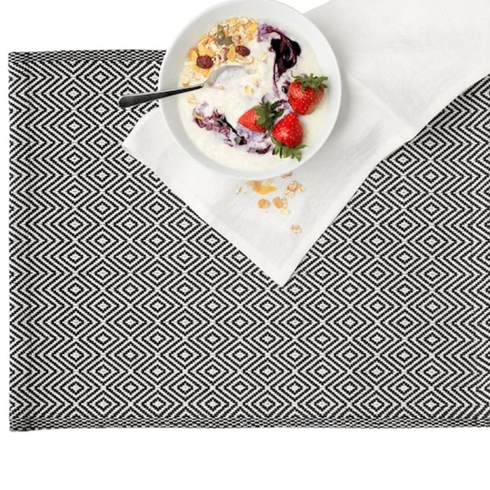 A rectangular placemat made of natural materials, with frayed edges 50342869