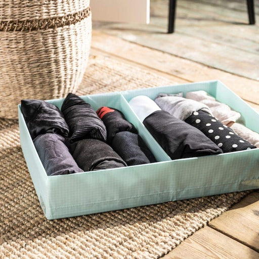 A  box with compartments designed for clothes storage, featuring two compartments for organizing different types of clothes in different ways  00471646