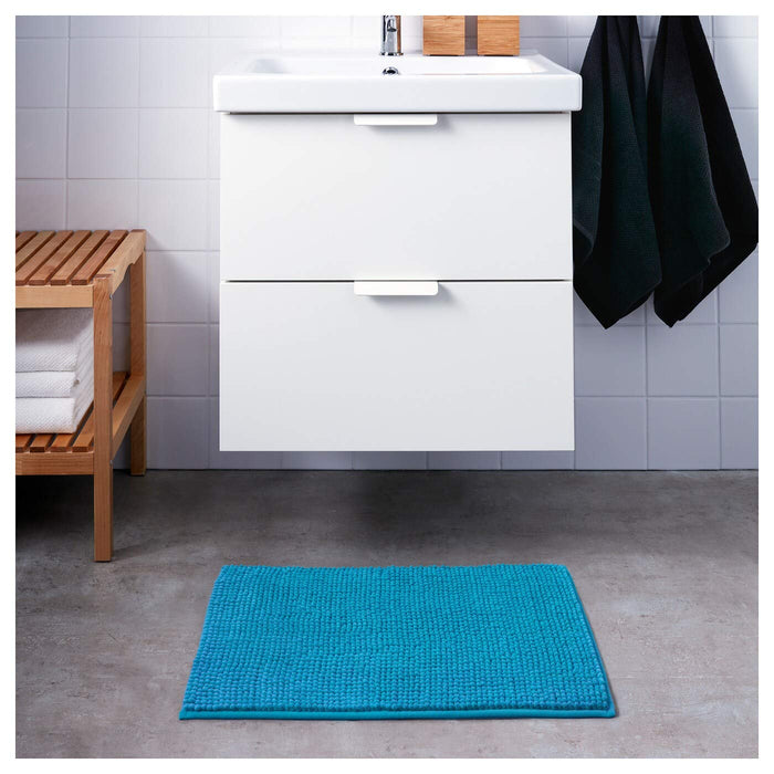 IKEA bath mat placed on a bathroom floor, featuring a soft and absorbent texture and a non-slip bottom for secure footing 20242423