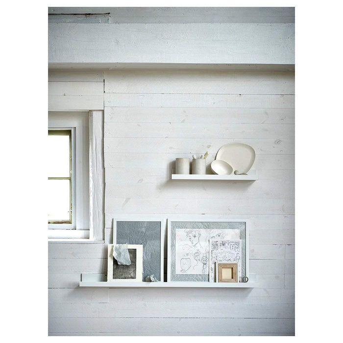 A wall with an installed IKEA Picture Ledge shelf displaying a mix of decorative items.  30297467