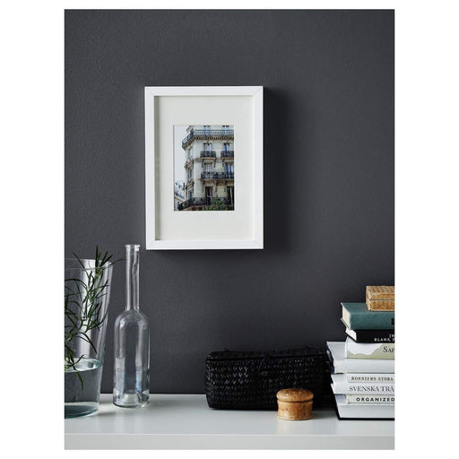 A minimalist white frame by IKEA, ideal for displaying 21x30 cm posters or photographs 60378400