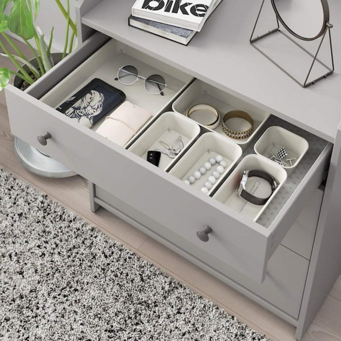 An IKEA office organization solution, featuring a desk with built-in storage and shelving units to keep paperwork and office supplies tidy and accessible.
