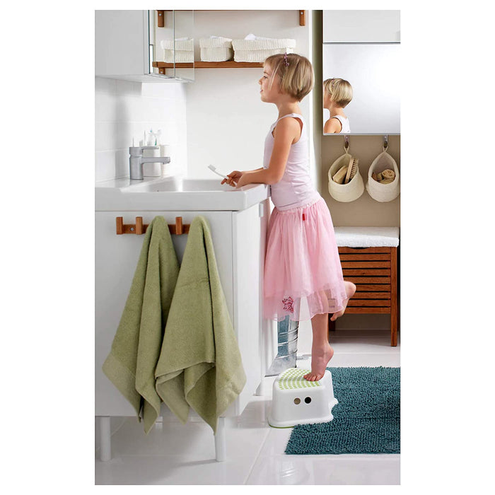 A child standing on the IKEA Children's Stool, showing its safe and reliable construction for everyday use 40248419