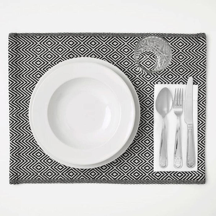 A rectangular placemat made of natural materials, with frayed edges  50342869