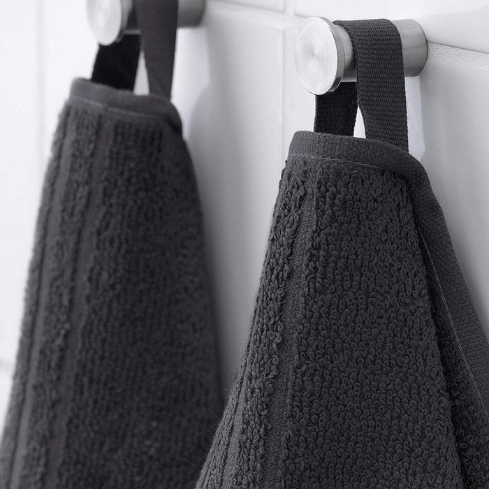 A close-up of a Dark Grey washcloth with a textured surface and a hanging loop.