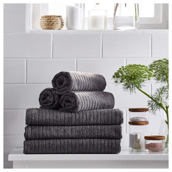  A pile of neatly folded Dark Grey hand towels with a stripe down the center 20353618