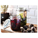 A functional clear glass container with a lid from IKEA, suitable for storing food and other items.