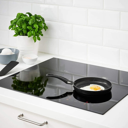 IKEA's 17cm black frying pan in use, showcasing its non-stick surface for effortless cooking and cleaning  50467963