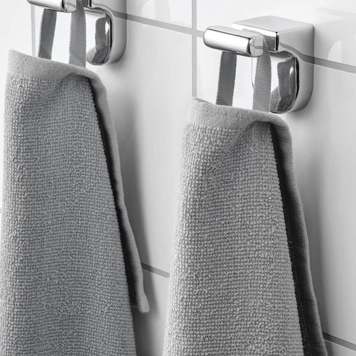 A close-up image of a simple and classic grey hand towel hanging on a bathroom80451116
