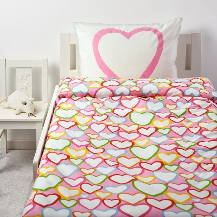 A cozy-looking bed with a colorful duvet cover and matching pillowcase from IKEA  50165833