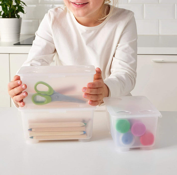 An IKEA transparent box with a white lid for easy storage and organization.