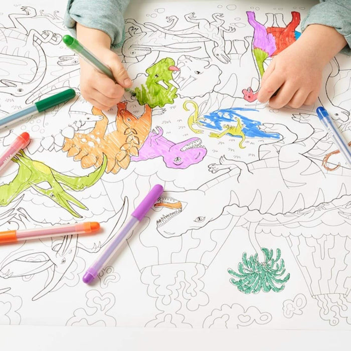 "IKEA Coloring Paper Roll displayed on a wooden table with coloring pencils and markers"