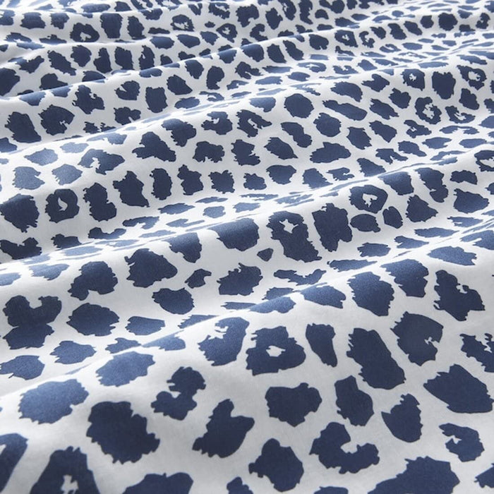 A closeup image of a Dark Blue/White duvet cover with a paisley pattern