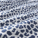 A closeup image of a Dark Blue/White duvet cover with a paisley pattern
