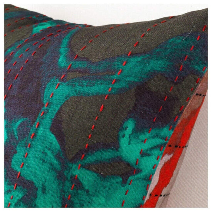 A close-up of an IKEA cushion cover in a textured green/red fabric, featuring a subtle pattern of light and dark woven threads,80434396