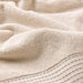 A plush light yellow towel, 70x140 cm, laid out on a bathroom countertop30508318       