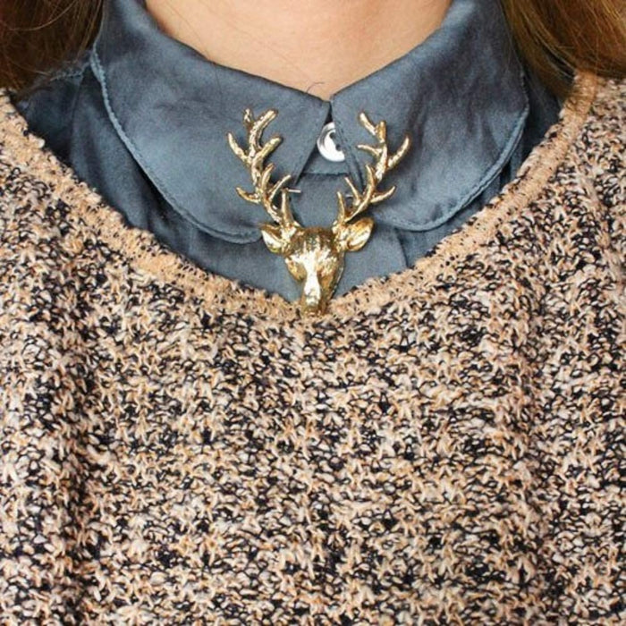 A women's jewelry brooch that adds a fashionable touch to any outfit with its elegant gold color collar pin and long horn deer elk head design.